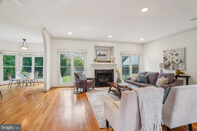 a living room with furniture large window and fireplace