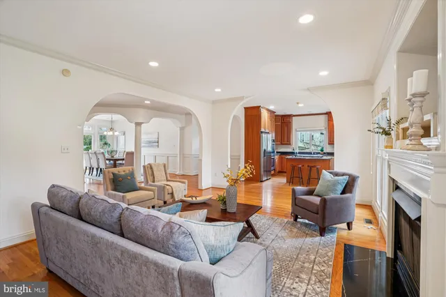 a living room with furniture fireplace and a large window