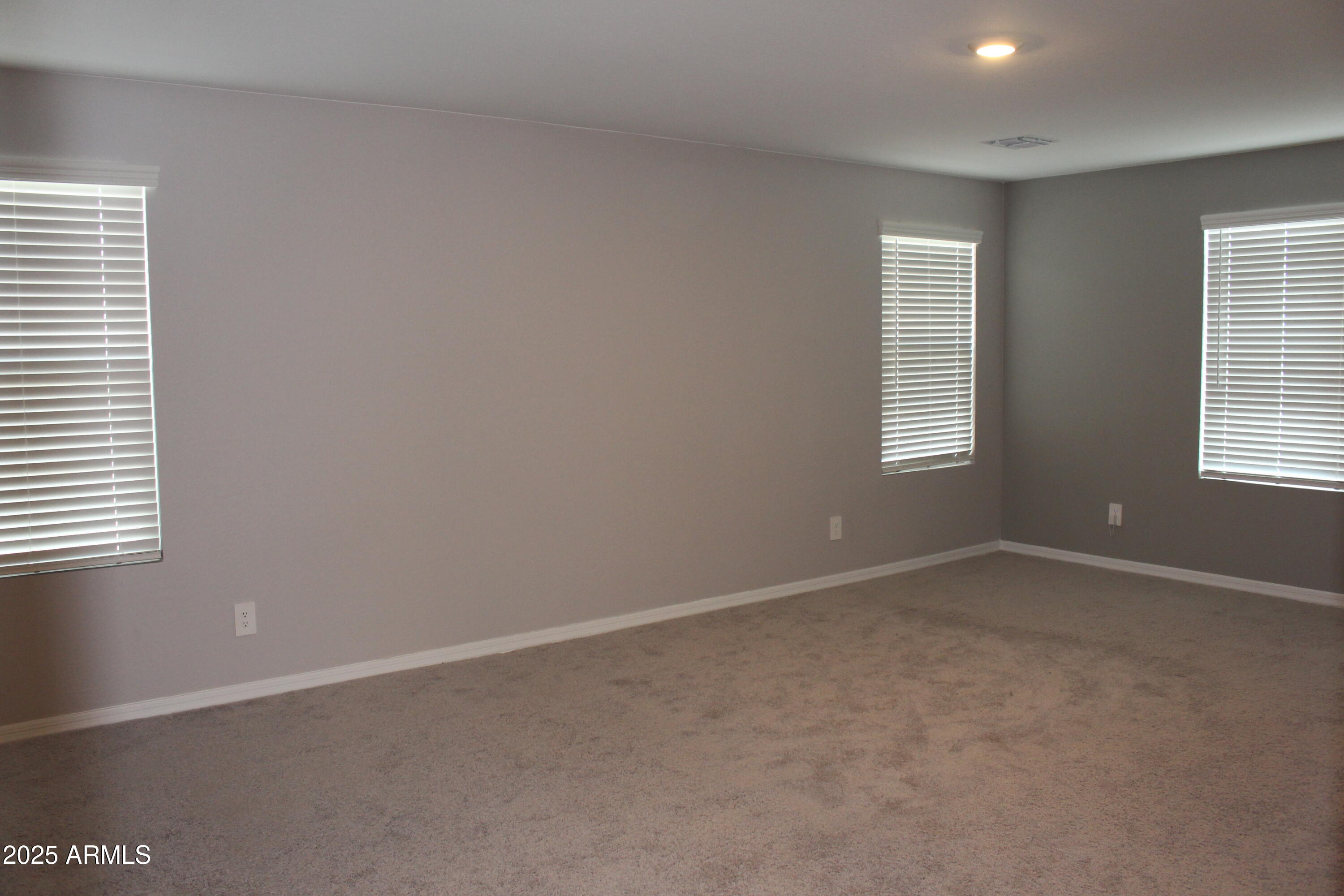 10805 West Levi Drive Tolleson, AZ 85353 - Photo 11 of 21 an empty room with windows