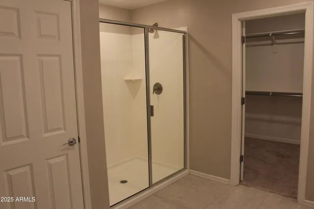 a bathroom with a glass shower door