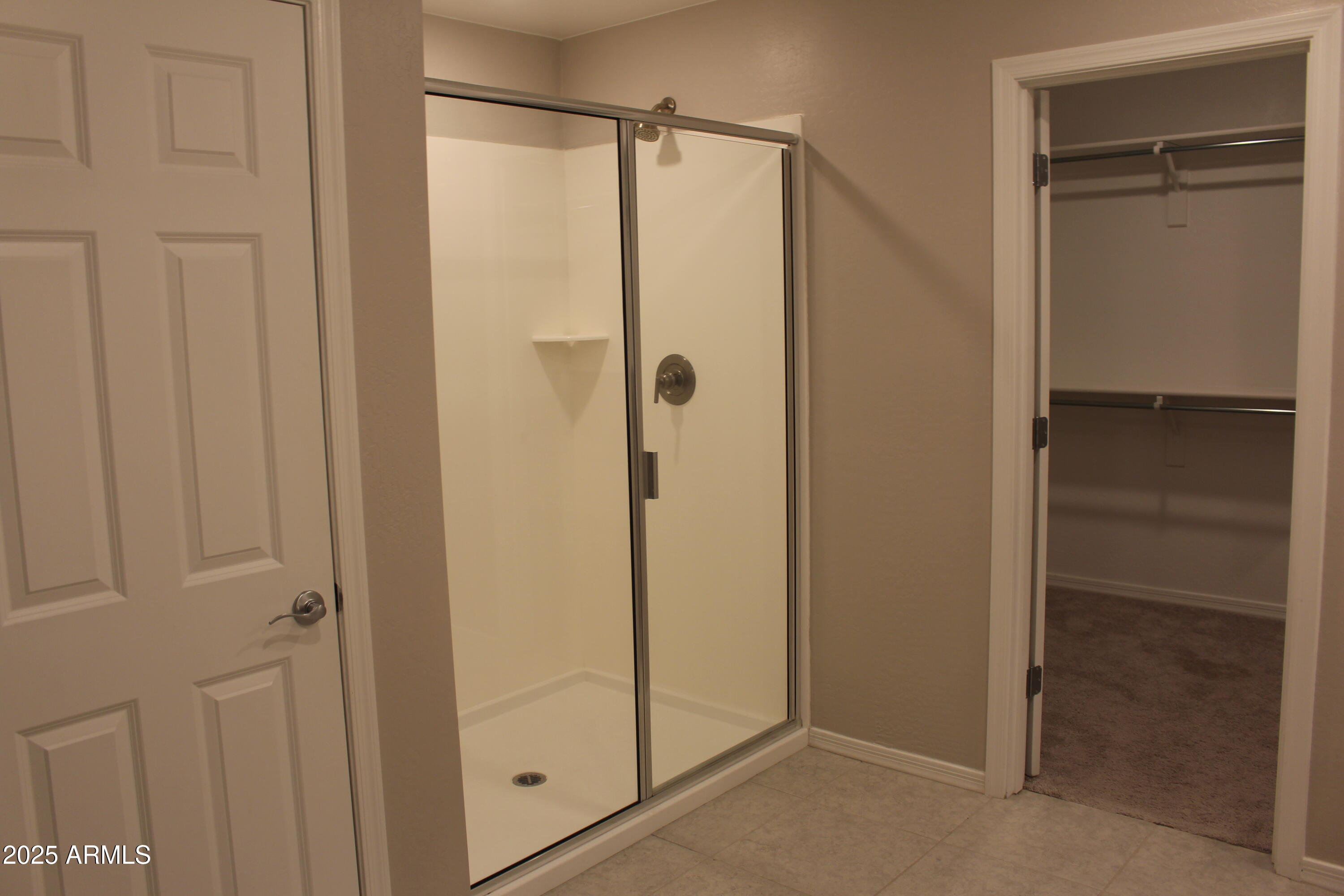 10805 West Levi Drive Tolleson, AZ 85353 - Photo 13 of 21 a bathroom with a glass shower door