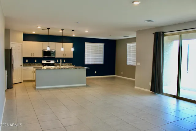 a view of a kitchen with a sink a microwave and cabinets
