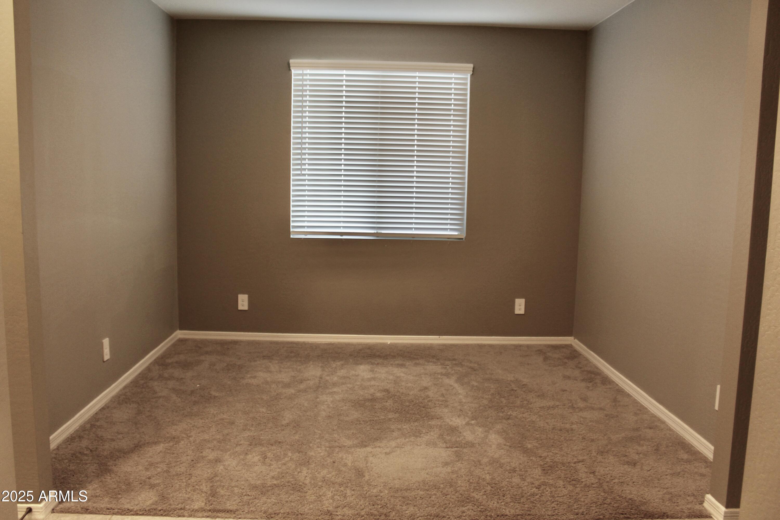 10805 West Levi Drive Tolleson, AZ 85353 - Photo 8 of 21 an empty room with a window