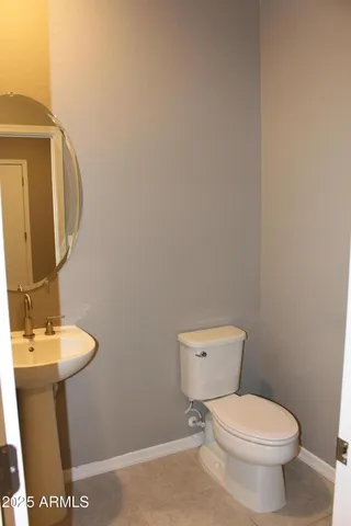 a white toilet sitting next to a bathroom sink