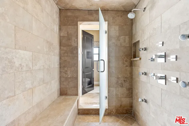 a bathroom with a glass shower door