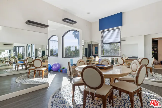 a view of a dining room with furniture a chandelier and wooden floor