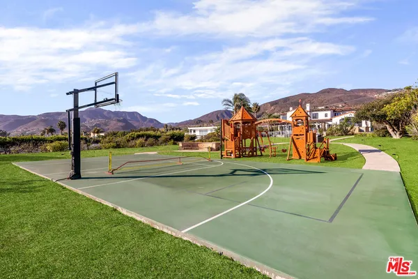 a view of a playground with basketball court