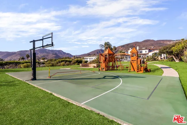 a view of a playground with basketball court