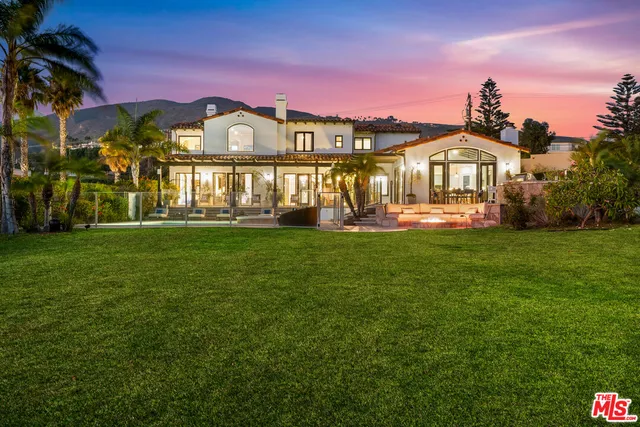 a front view of a building with a garden