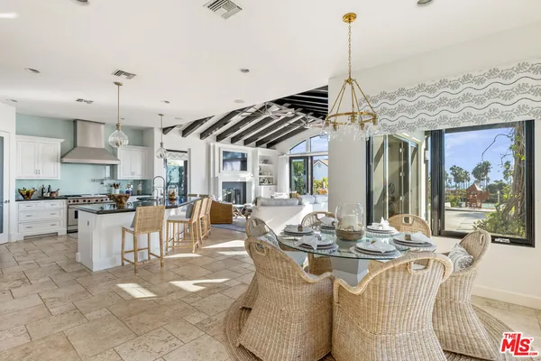a dining hall with couches a flat screen tv and dining table