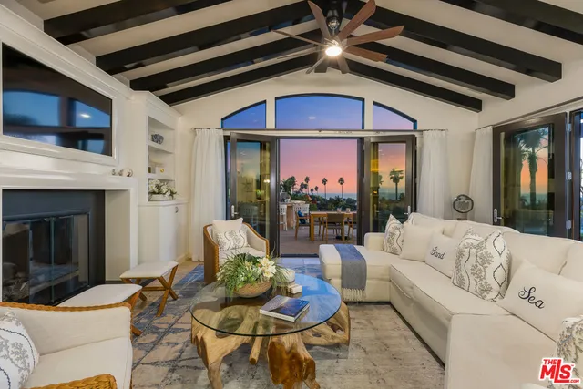 a living room with furniture fireplace and flat screen tv