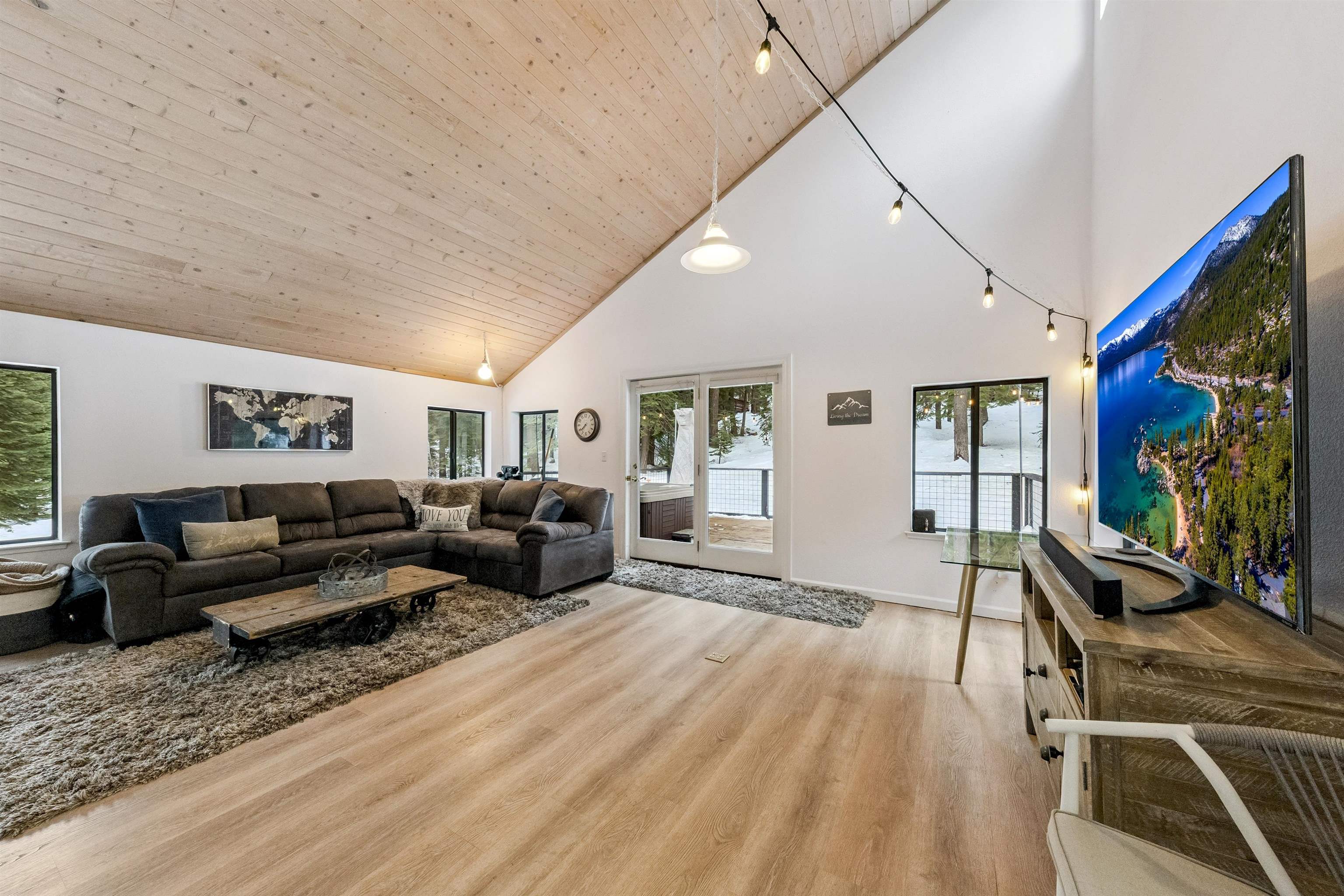 1141 Regency Way Tahoe Vista, CA 96148 - Photo 18 of 28 a living room with furniture a flat screen tv and a large window