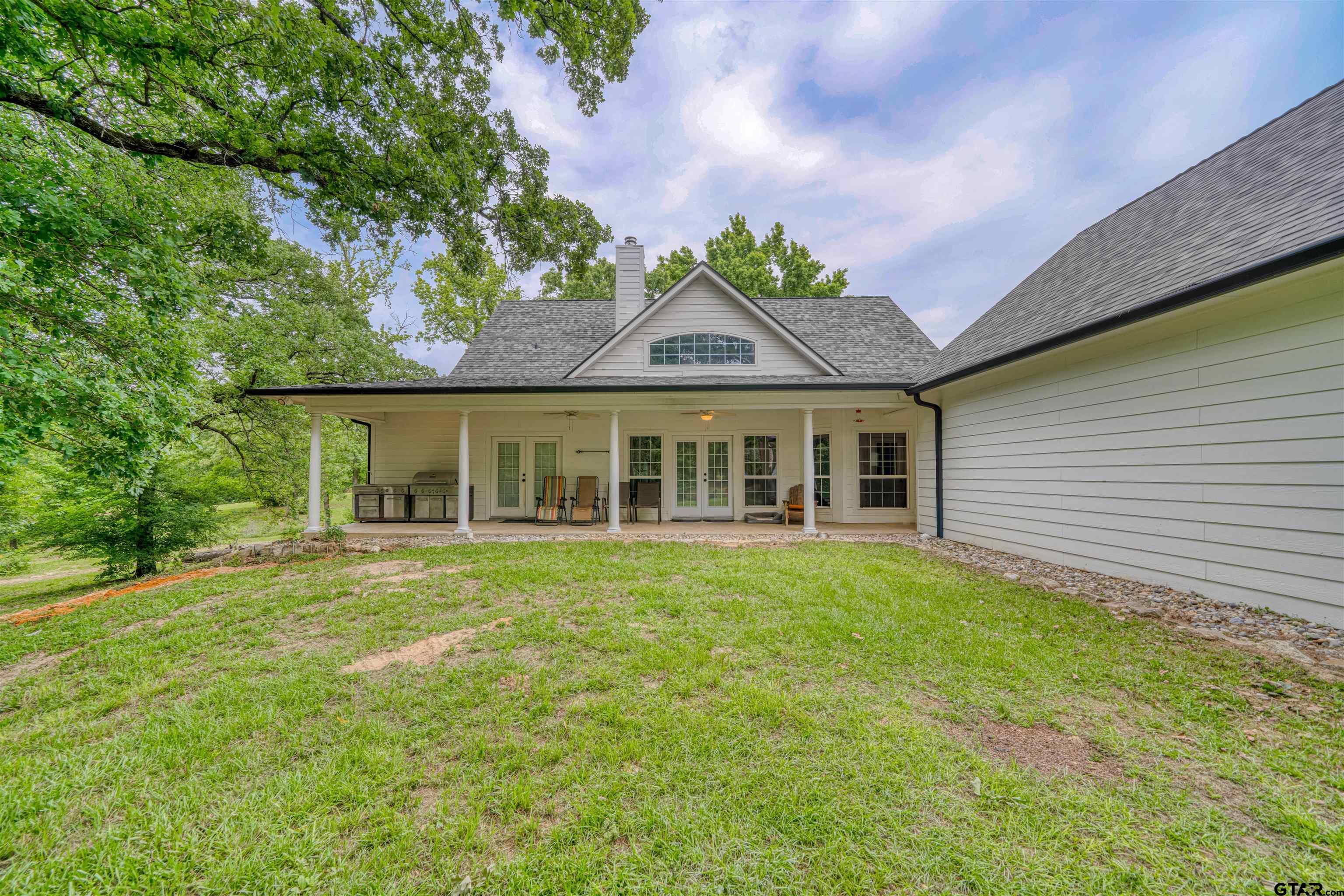 1776 Mustang Road Gilmer, TX 75645 - Photo 7 of 45 a front view of a house with a garden