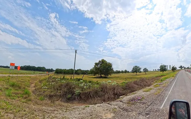 a view of a golf course with a wooden fence