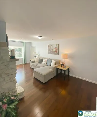 a living room with furniture and a lamp
