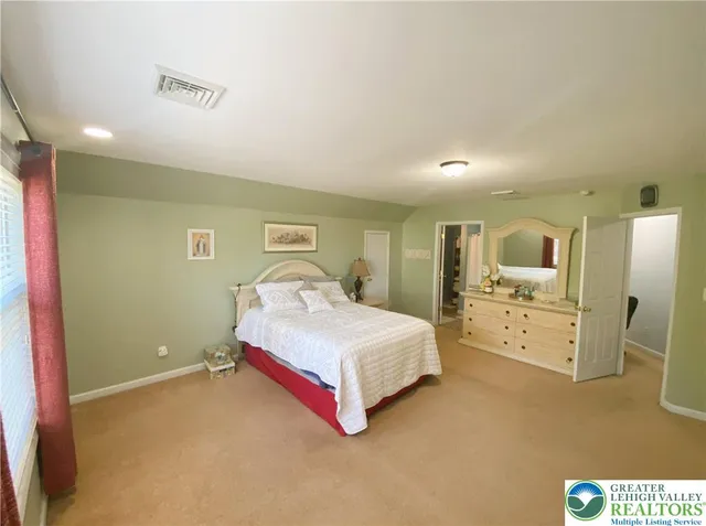 a bedroom with a bed a table and chair