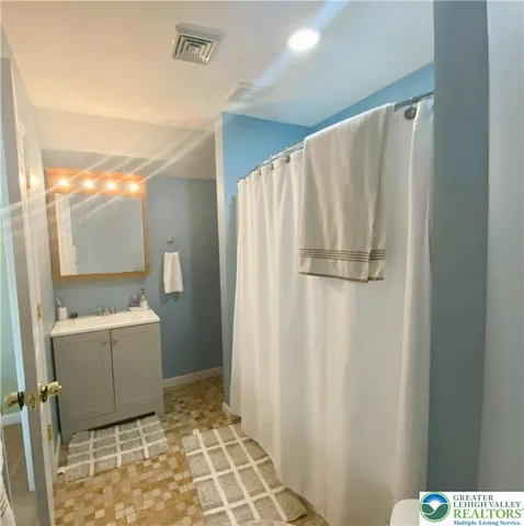 a bathroom with a sink a toilet and a mirror