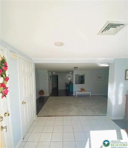 a view of a hallway with wooden shelves
