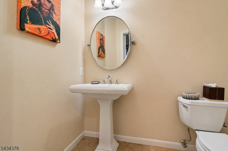 606 Park Place Springfield, NJ 07081 - Photo 19 of 21 a bathroom with a toilet sink and mirror