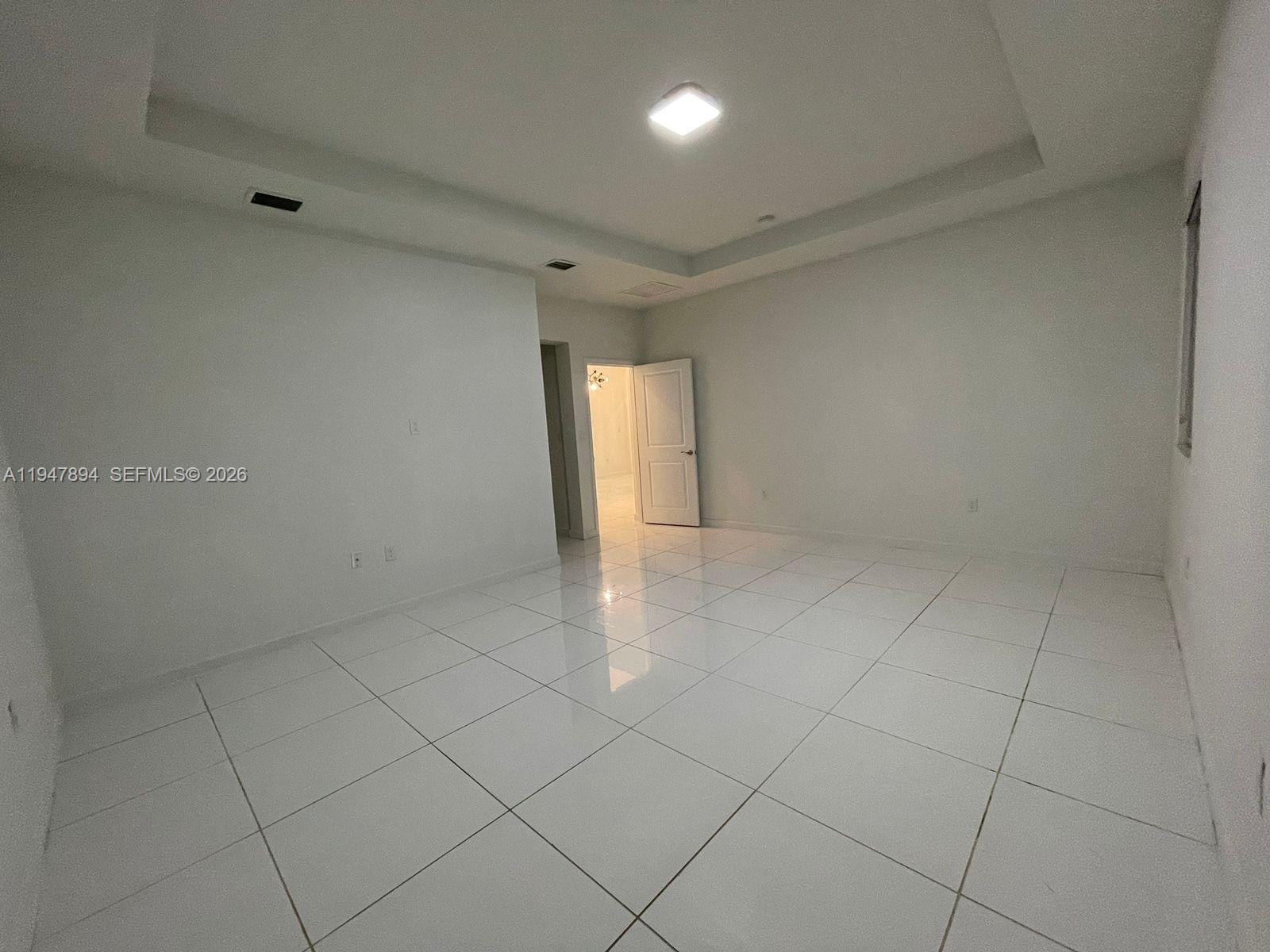 4451 Southwest 159th Path Miami, FL 33185 - Photo 15 of 24 an empty room with white walls and tiles