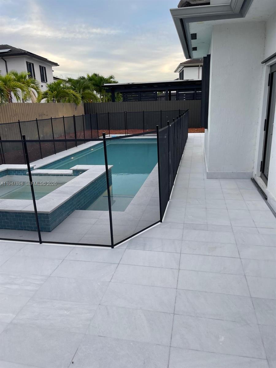 4451 Southwest 159th Path Miami, FL 33185 - Photo 19 of 24 a terrace with a bench