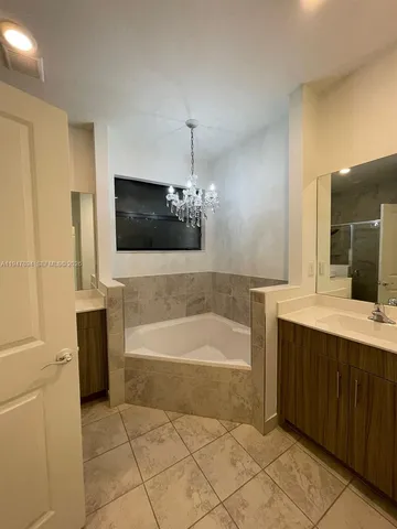 a bathroom with a sink a mirror and bathtub