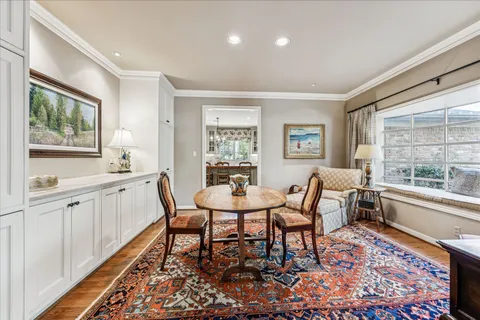 a view of a dining room with furniture a rug and wooden floor