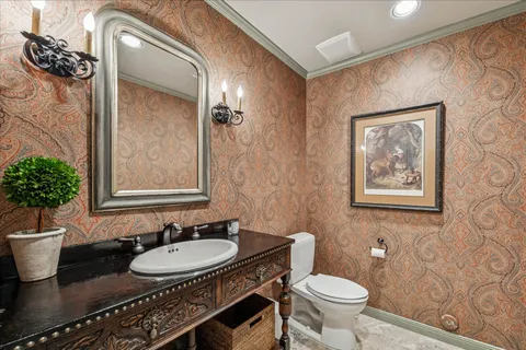 a bathroom with a toilet sink and mirror