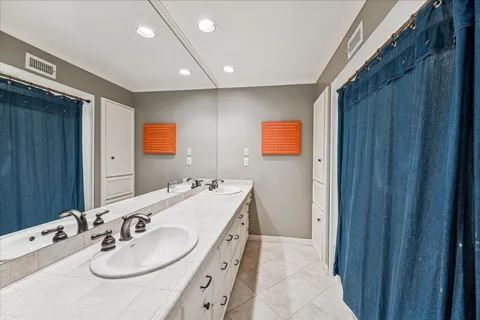 a bathroom with a sink double vanity and a mirror