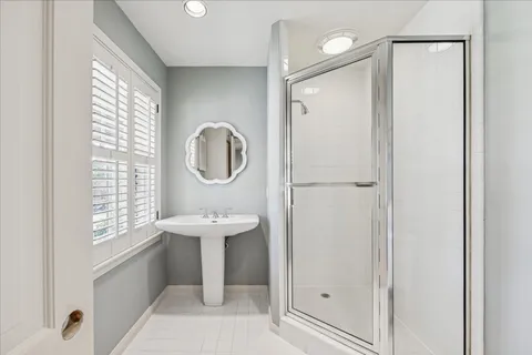 a bathroom with a sink a mirror and a window