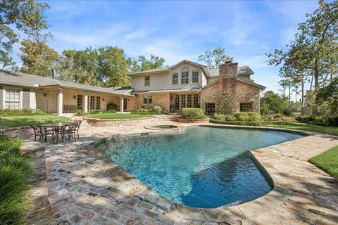 a view of a house with yard and sitting area