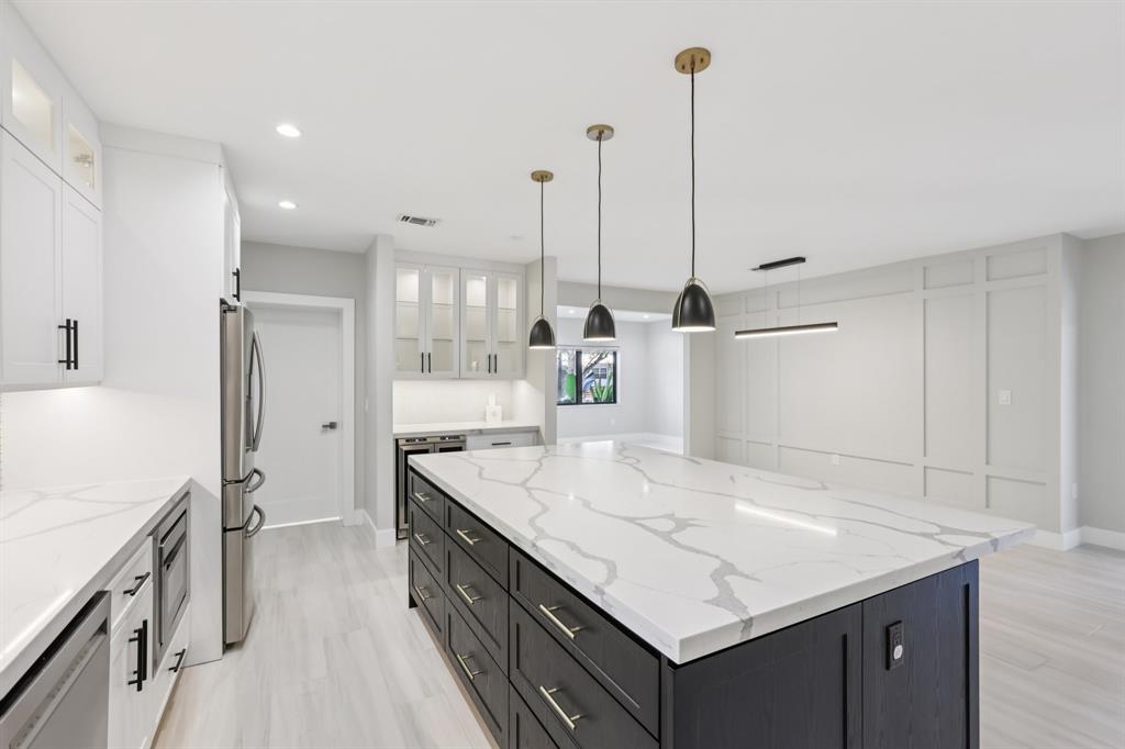1660 Southwest 32nd Court Miami, FL 33145 - Photo 12 of 34 a kitchen with kitchen island a sink appliances and a counter top space