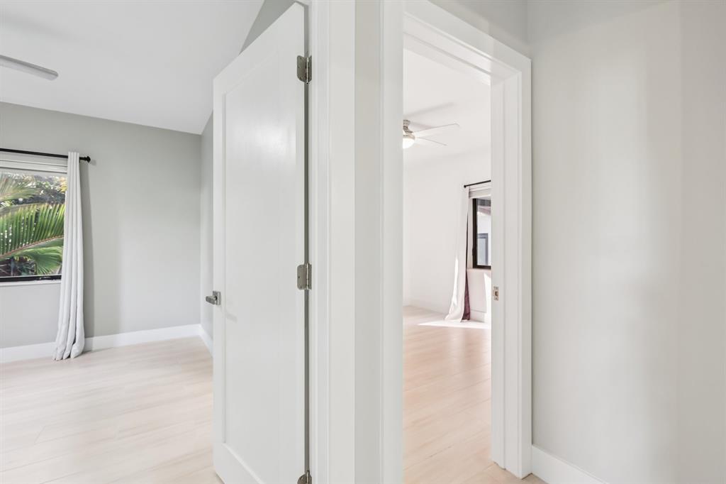 1660 Southwest 32nd Court Miami, FL 33145 - Photo 19 of 34 a view of a hallway with wooden floor and a bathroom