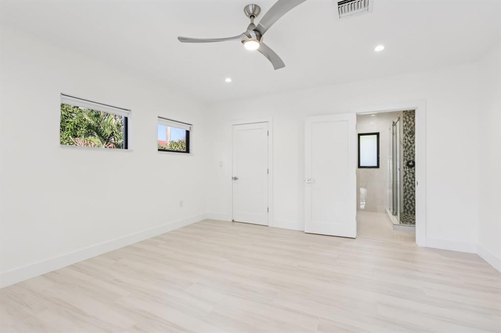 1660 Southwest 32nd Court Miami, FL 33145 - Photo 20 of 34 an empty room with windows and ceiling fan