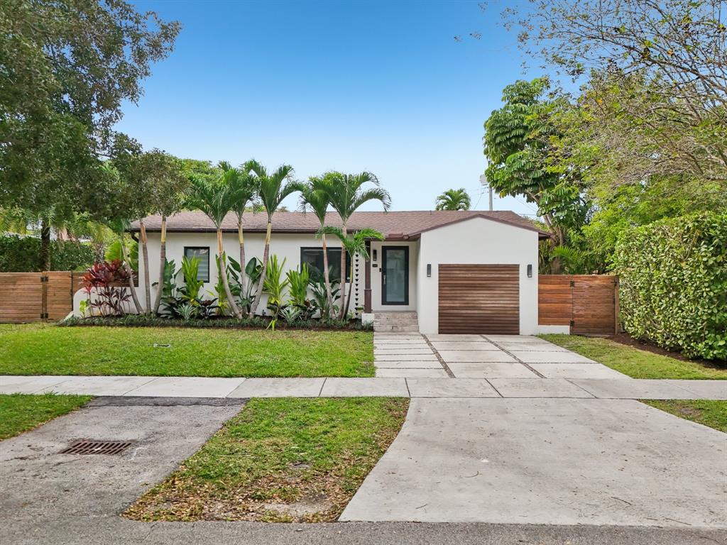 1660 Southwest 32nd Court Miami, FL 33145 - Photo 2 of 34 a front view of a house with a garden and plants