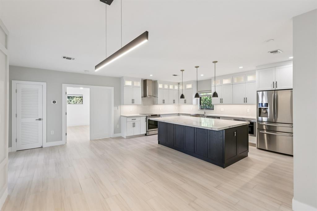 1660 Southwest 32nd Court Miami, FL 33145 - Photo 8 of 34 a large kitchen with kitchen island a sink stainless steel appliances and cabinets