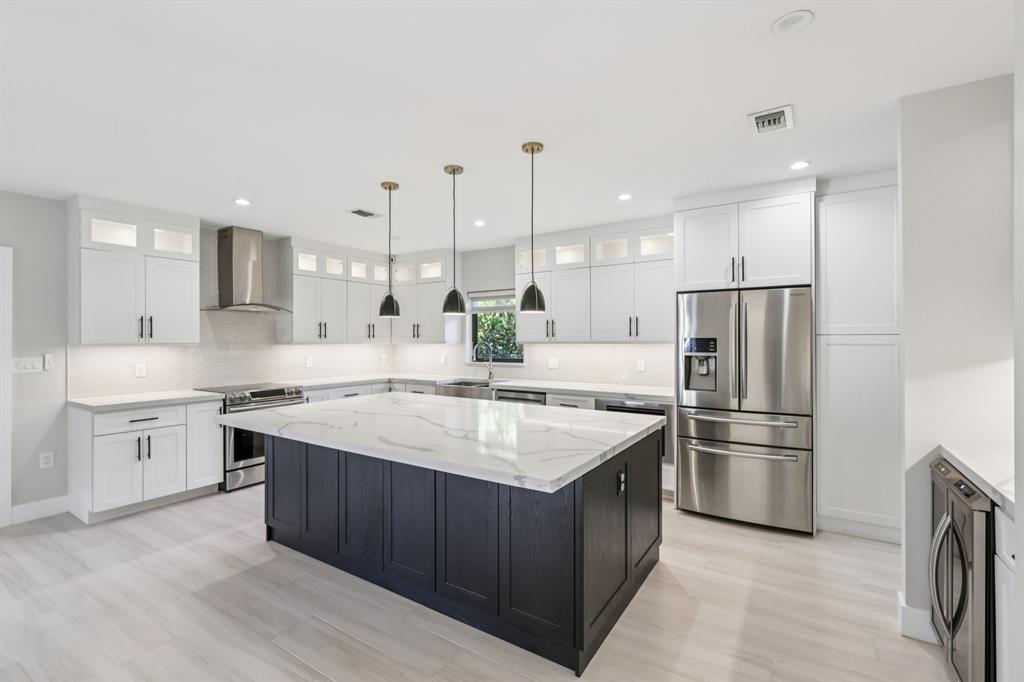 1660 Southwest 32nd Court Miami, FL 33145 - Photo 9 of 34 a kitchen with kitchen island a sink stainless steel appliances and cabinets