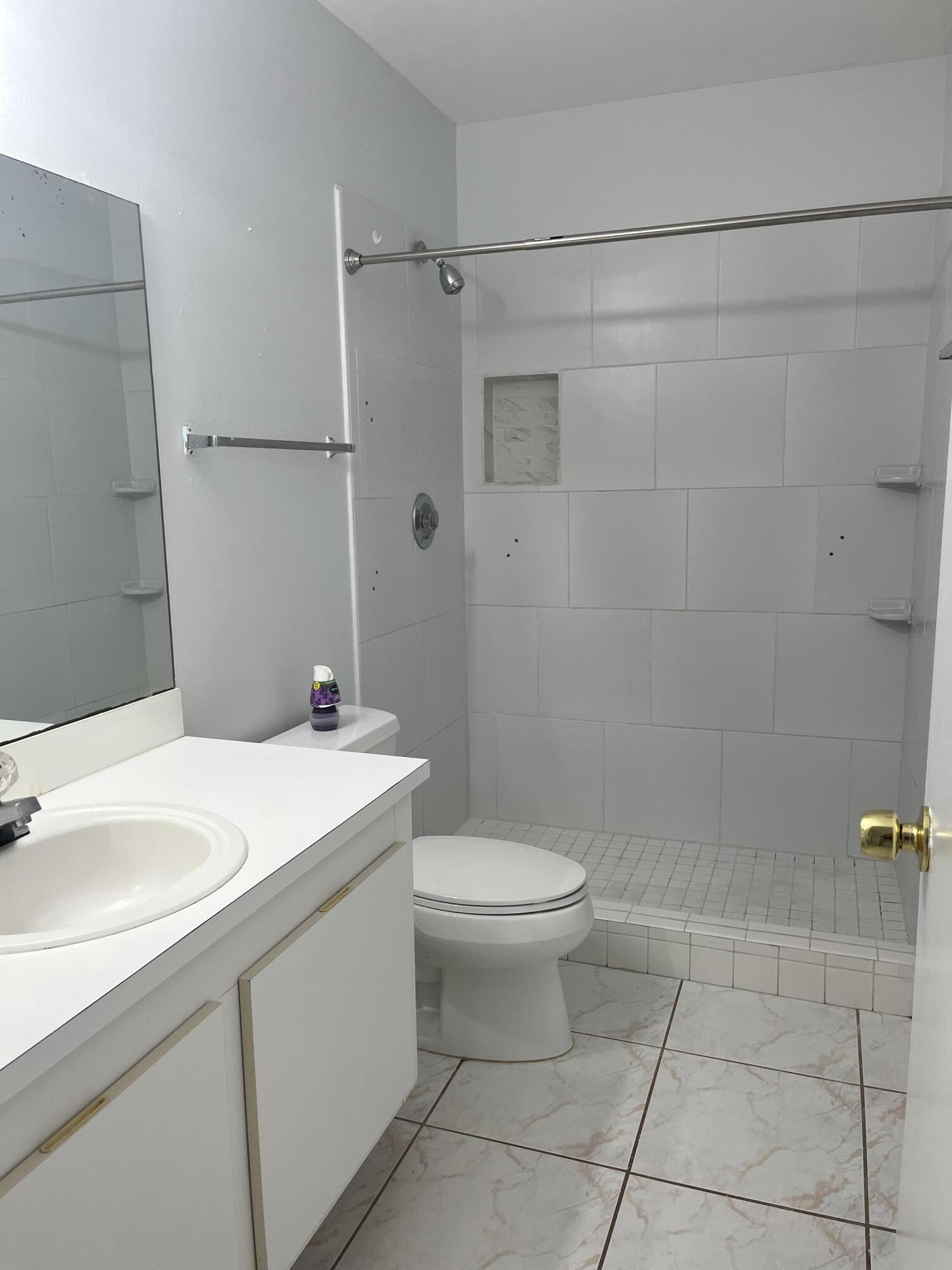 2103 Waterview Circle Palm Springs, FL 33461 - Photo 13 of 16 a bathroom with a sink toilet and shower