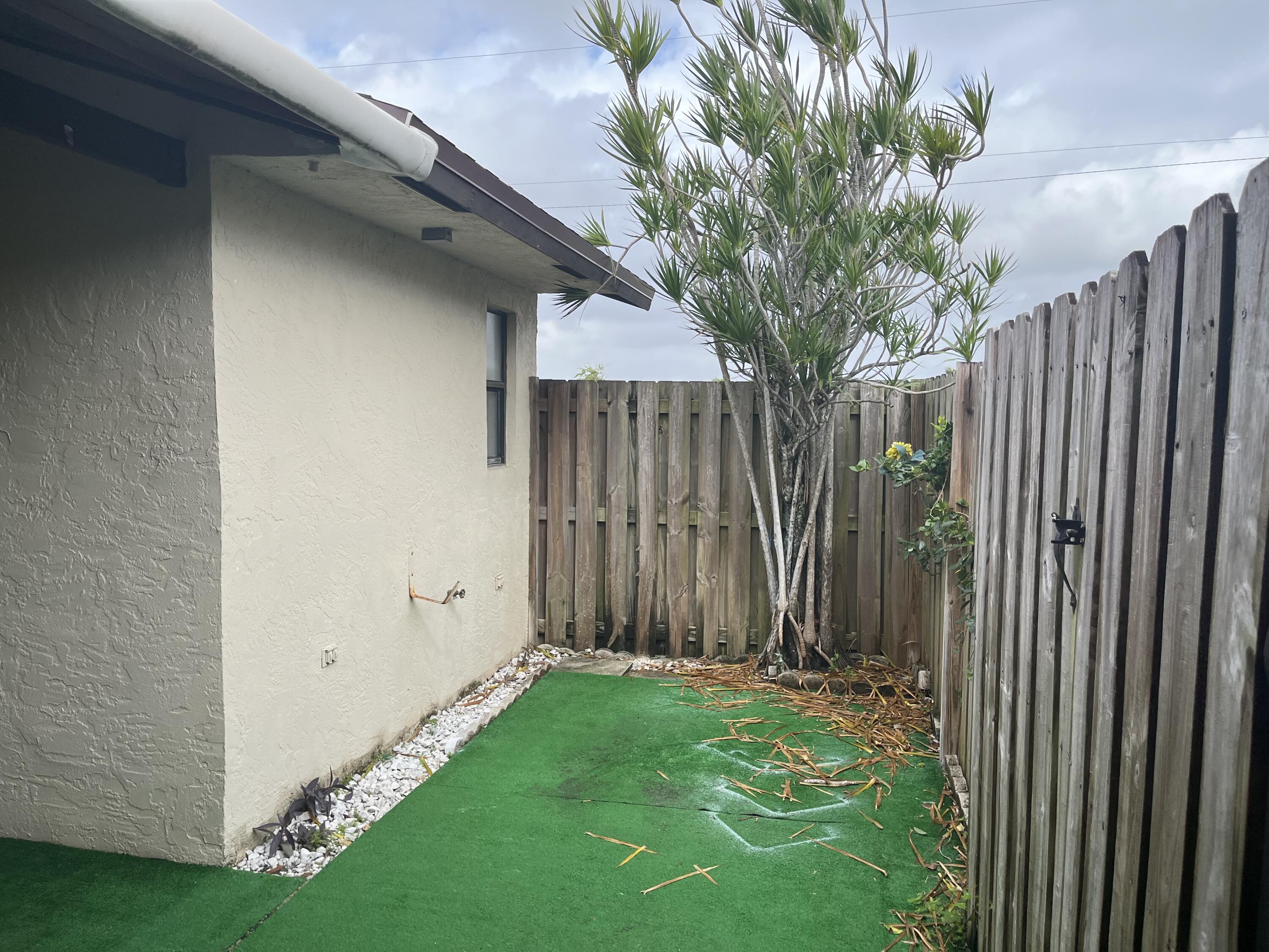 2103 Waterview Circle Palm Springs, FL 33461 - Photo 14 of 16 a house with a tree in front of it