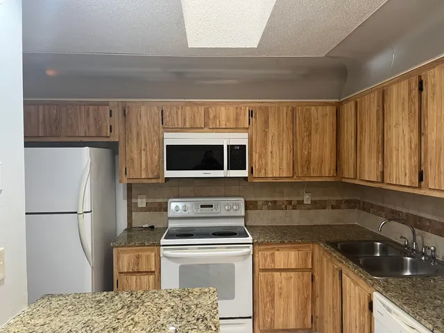 a kitchen with a sink a stove and refrigerator