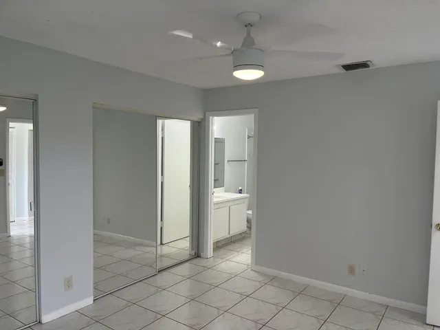 a bathroom with a granite countertop sink mirror toilet and bathtub