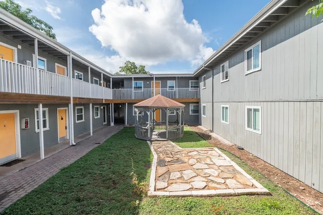 a front view of a house with a yard table and chairs