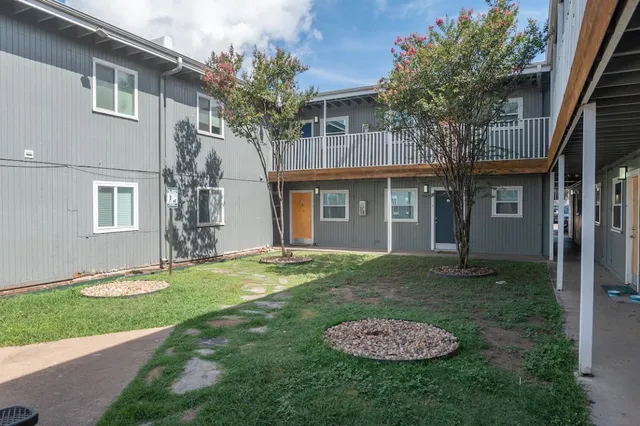 a backyard of a house with barbeque oven table and chairs