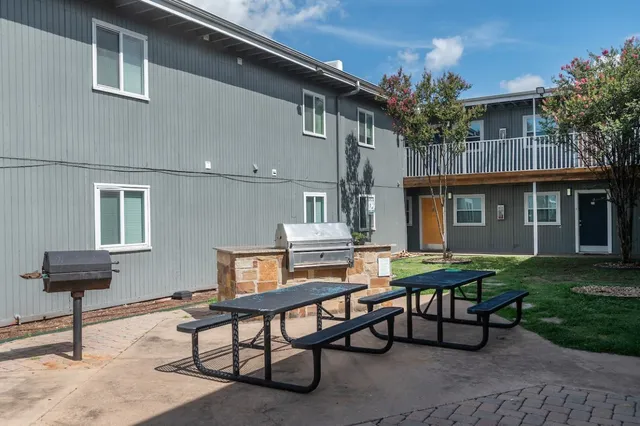a view of a house with backyard and sitting area