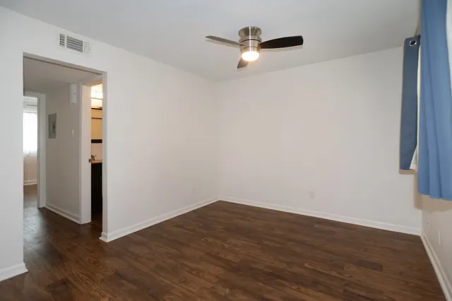 a view of a room with wooden floor