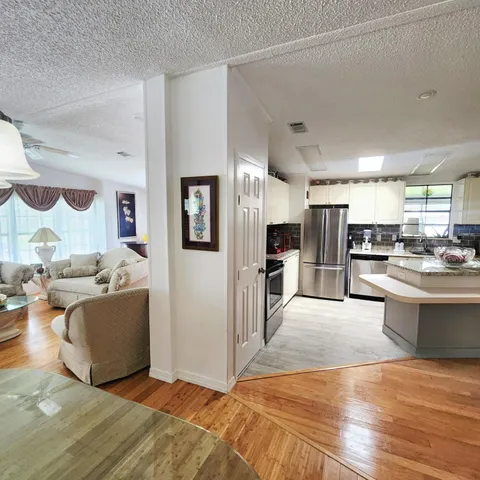 a kitchen with granite countertop a stove and a microwave