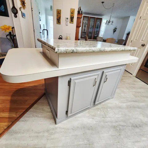 a view of a hallway with wooden floor and a window