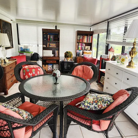 a view of a house with a yard and sitting area