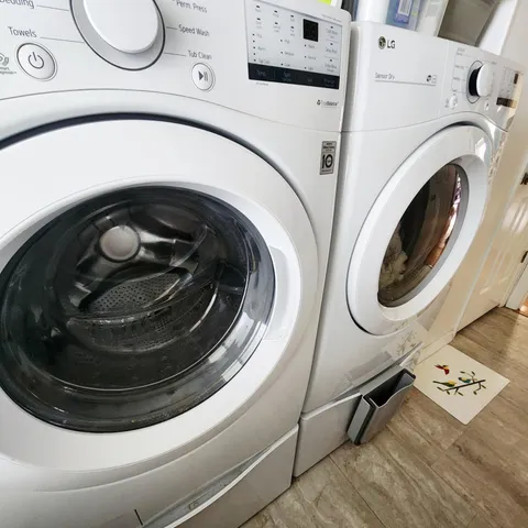 a front view of a house with a yard and potted plants