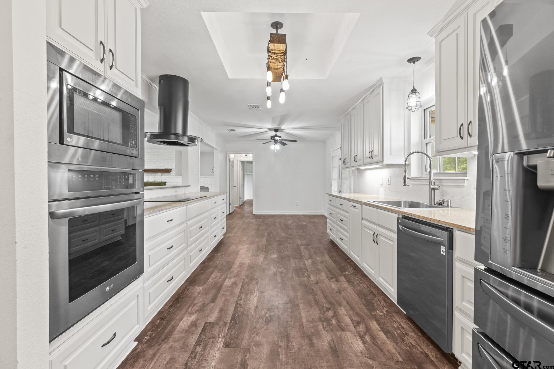 22741 County Road 448 Lindale, TX 75771 - Photo 18 of 48 a large kitchen with a large stove top oven and stainless steel appliances